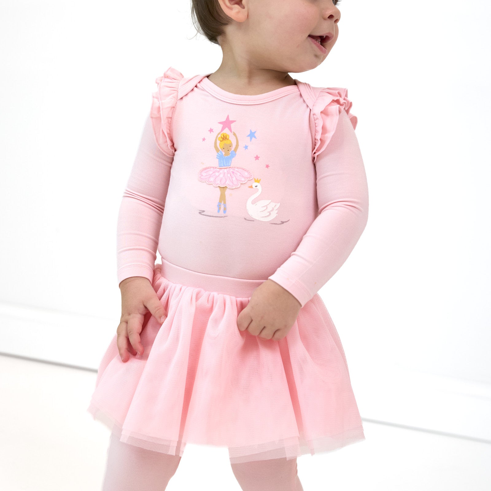 Close up image of child wearing the Prima Pink Flutter Bodysuit