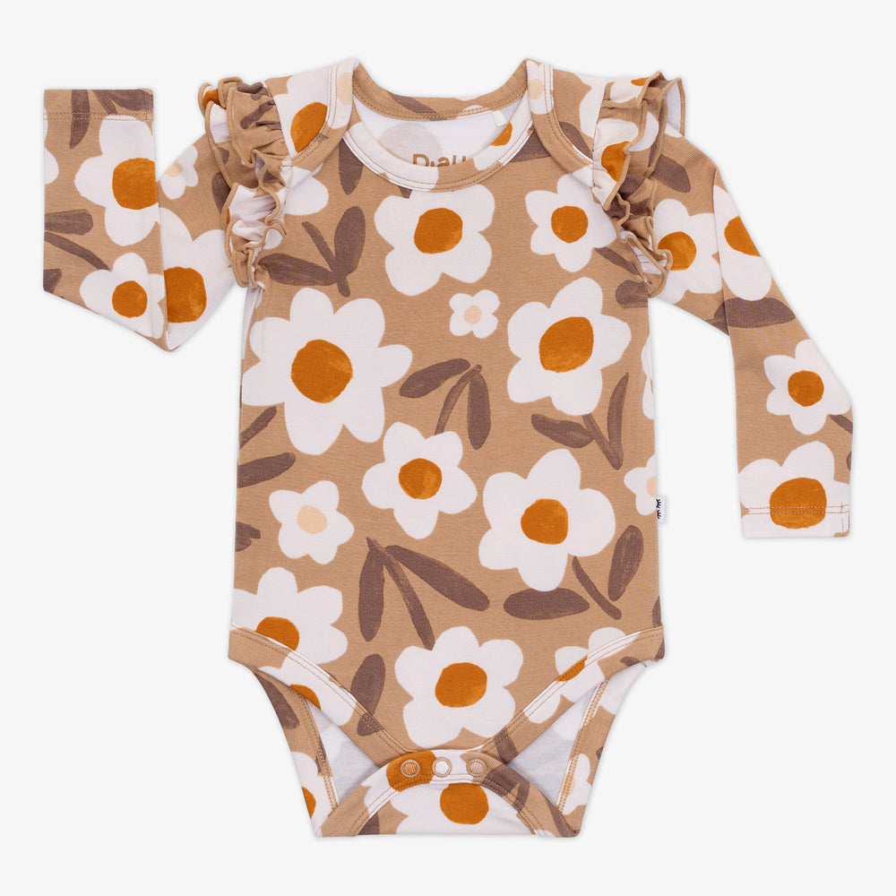 Flat lay of a Daisy Daydream flutter baby bodysuit featuring a tan floral design, shoulder ruffles, and long sleeves