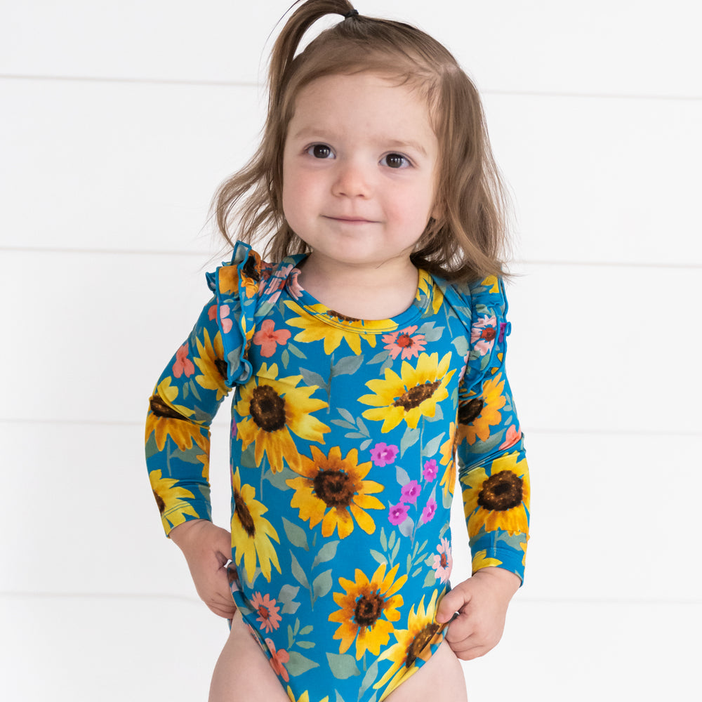 Close up image of a child wearing a Sunflower Fields Flutter Bodysuit