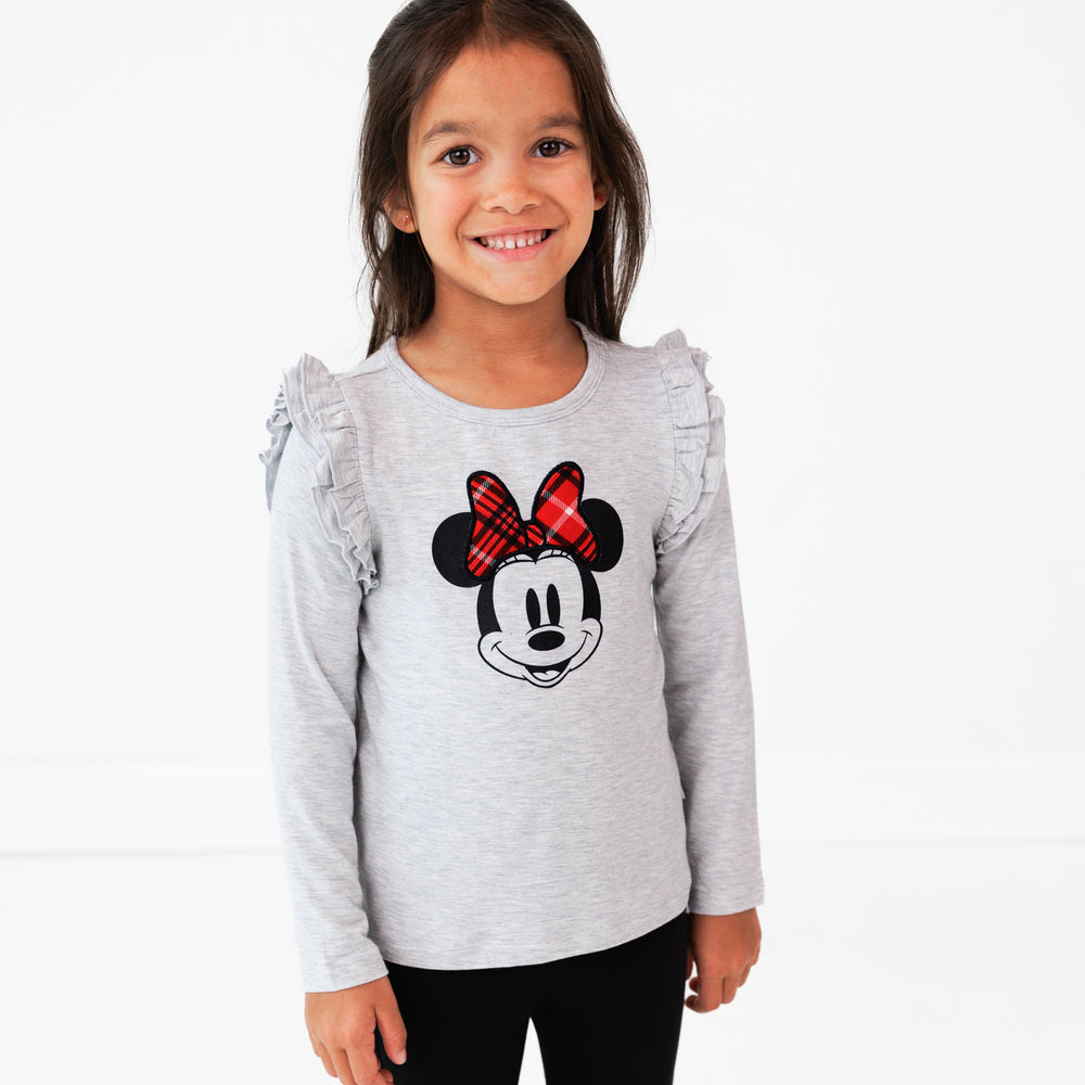 Image of a child wearing a Vintage Minnie Flutter Tee and Black Denim Jegging