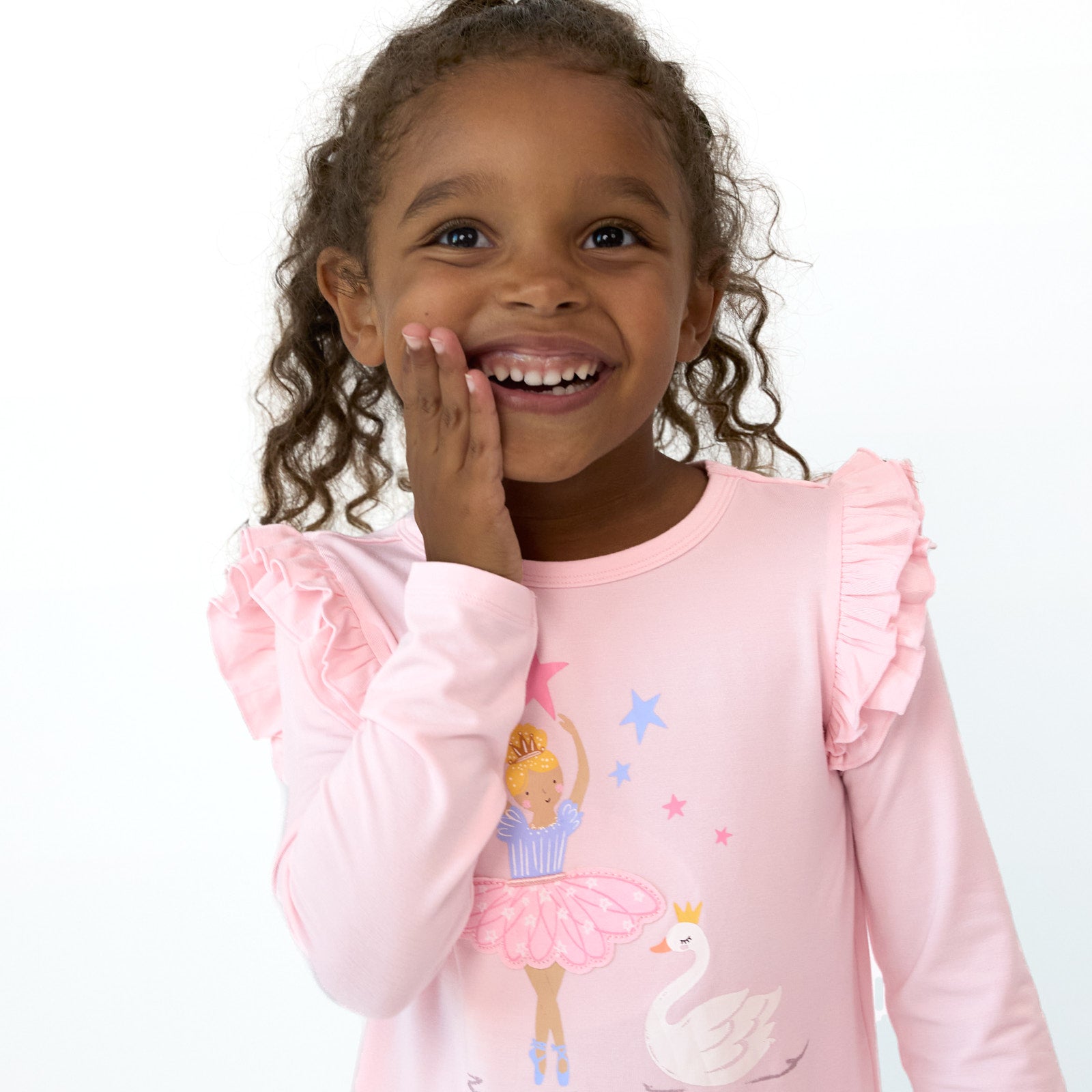 Close up image of smiling girl wearing the Prima Pink Flutter Tee