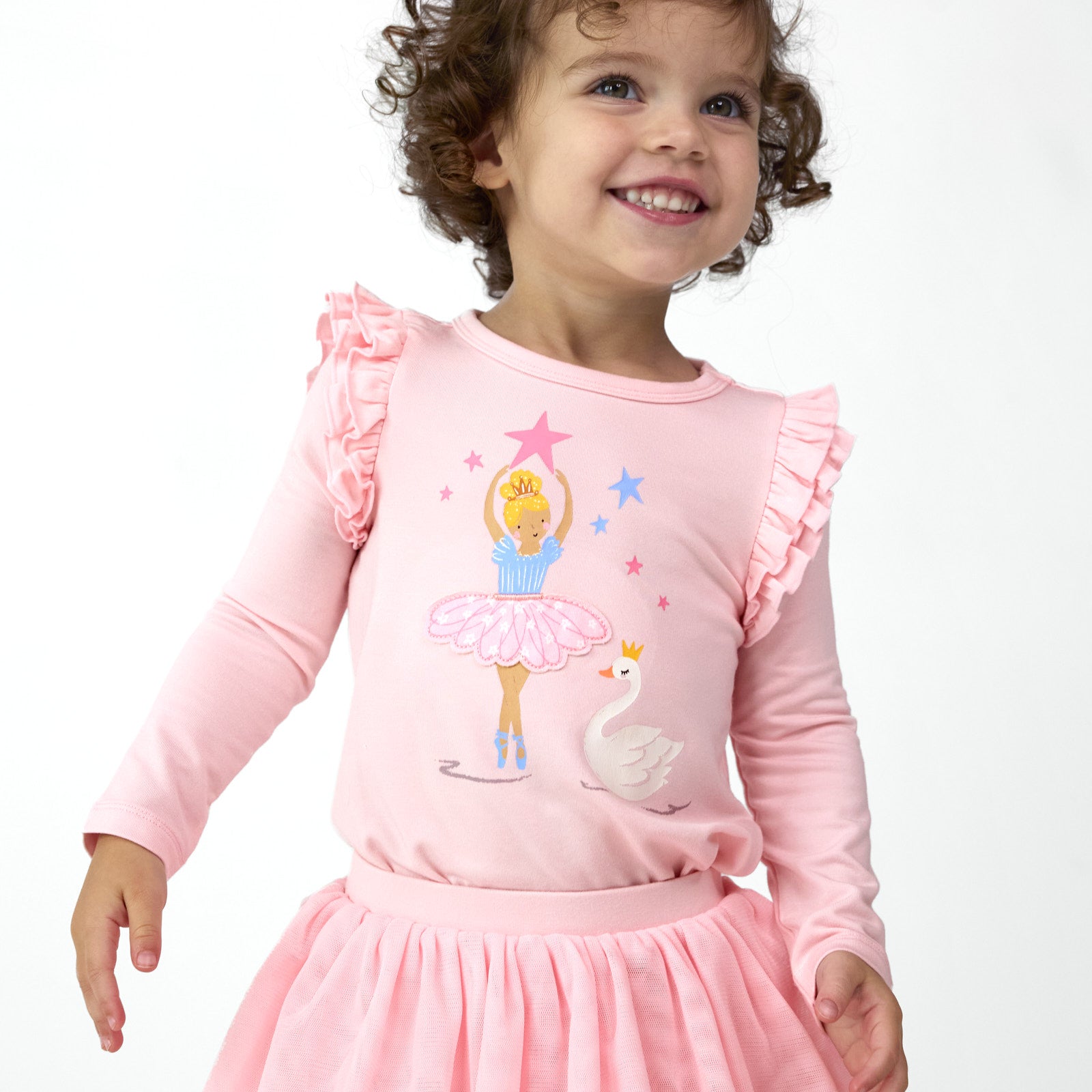 Smiling girl wearing the Prima Pink Flutter Tee with Prima Pink Tutu Leggings