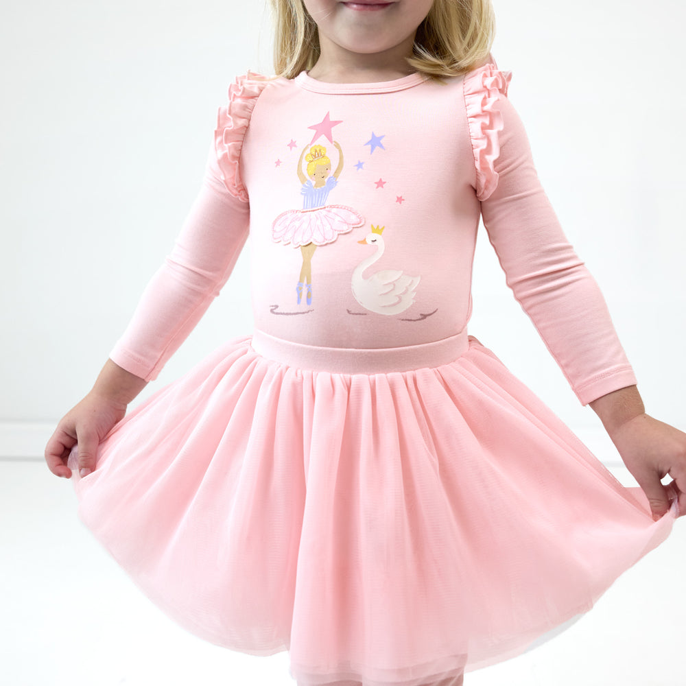 Close up image of girl wearing the Prima Pink Flutter Tee and posing with the Prima Pink Tutu Leggings