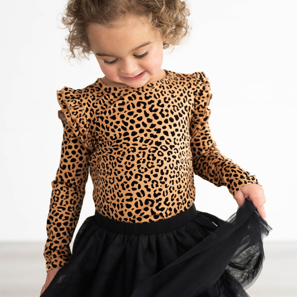 Girl posing while in the Classic Leopard Flutter Tee and Black Tutu Skirt