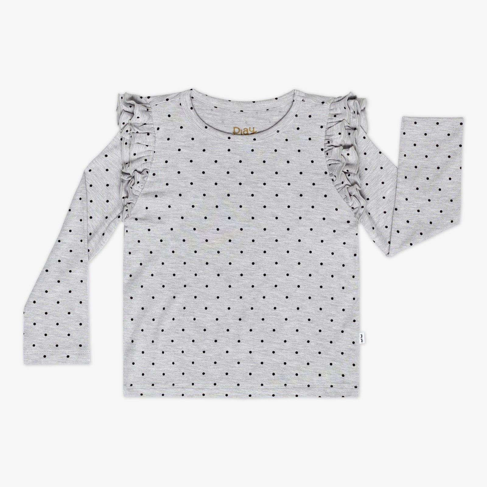 Flat lay of a Ditsy Dots flutter tee featuring long sleeves, ruffle shoulders, and black dots on a gray background