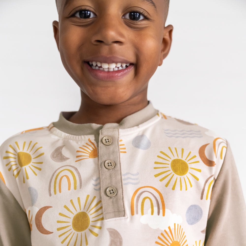 Close up image of a child wearing a Desert Sunrise Henley Tee