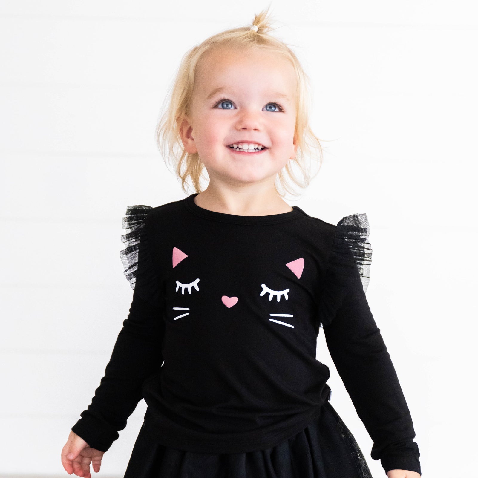 Girl wearing the Black Cat Graphic Flutter Tee