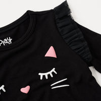 Close up flat lay image of the shoulder detail on the Black Cat Graphic Flutter Tee