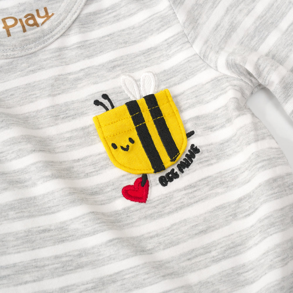 close up view of the embroidered bee pocket on a bee mine pocket bodysuit