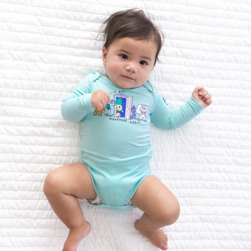 Additional top view image of baby laying down while wearing the Disney Monsters, Inc. Bodysuit