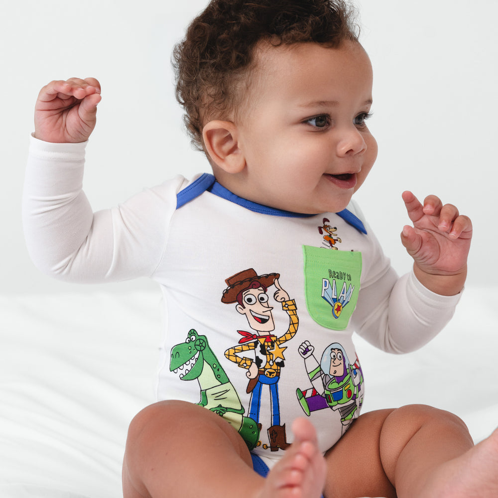 Infant sitting on a blanket wearing a Disney & Pixar Toy Story Pals Bodysuit