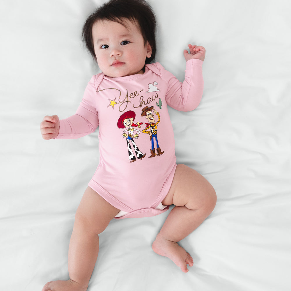 Infant lying on a blanket wearing a Disney & Pixar Jessie & Woody Bodysuit