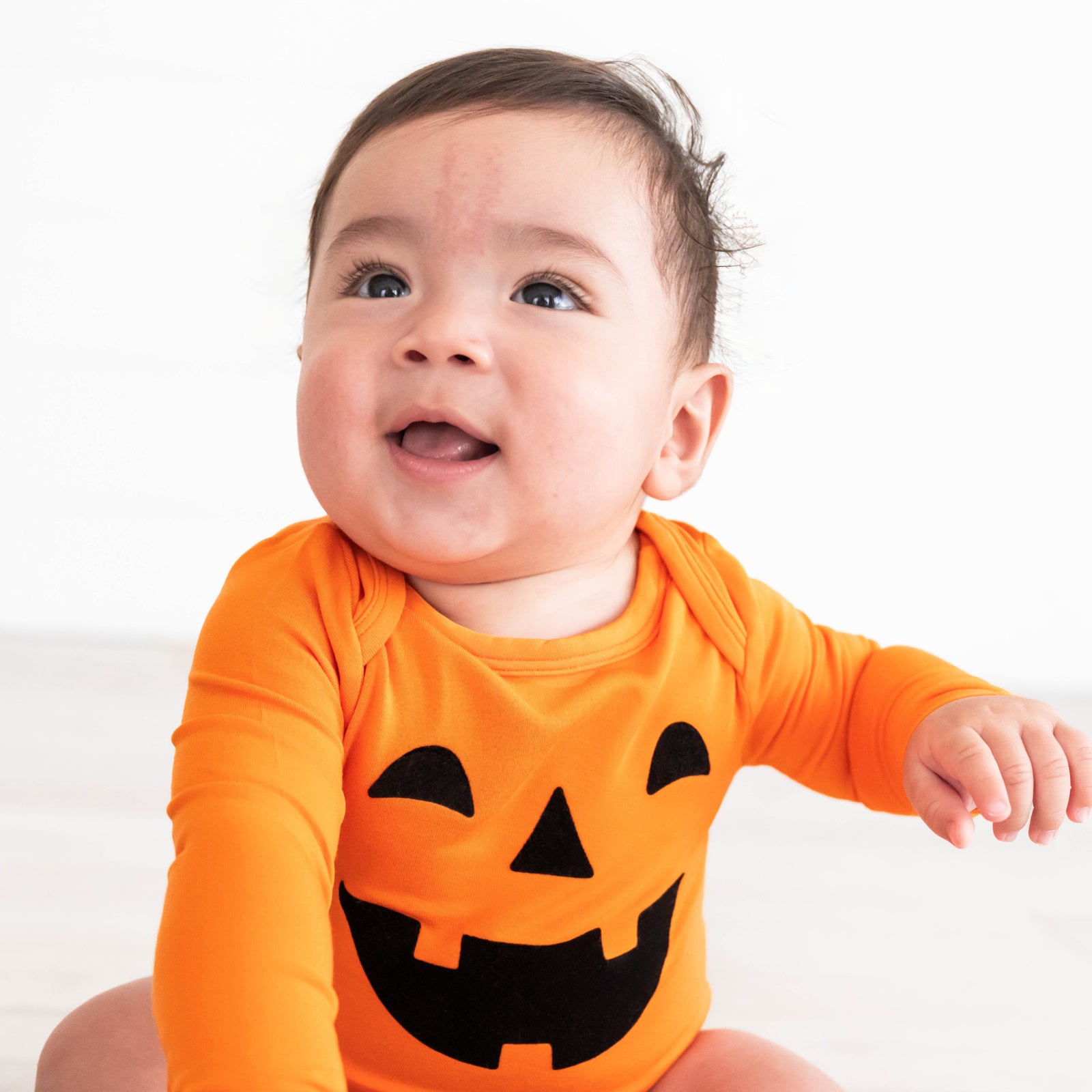 Close up image of baby wearing the Jack-O'-Lantern Graphic Bodysuit