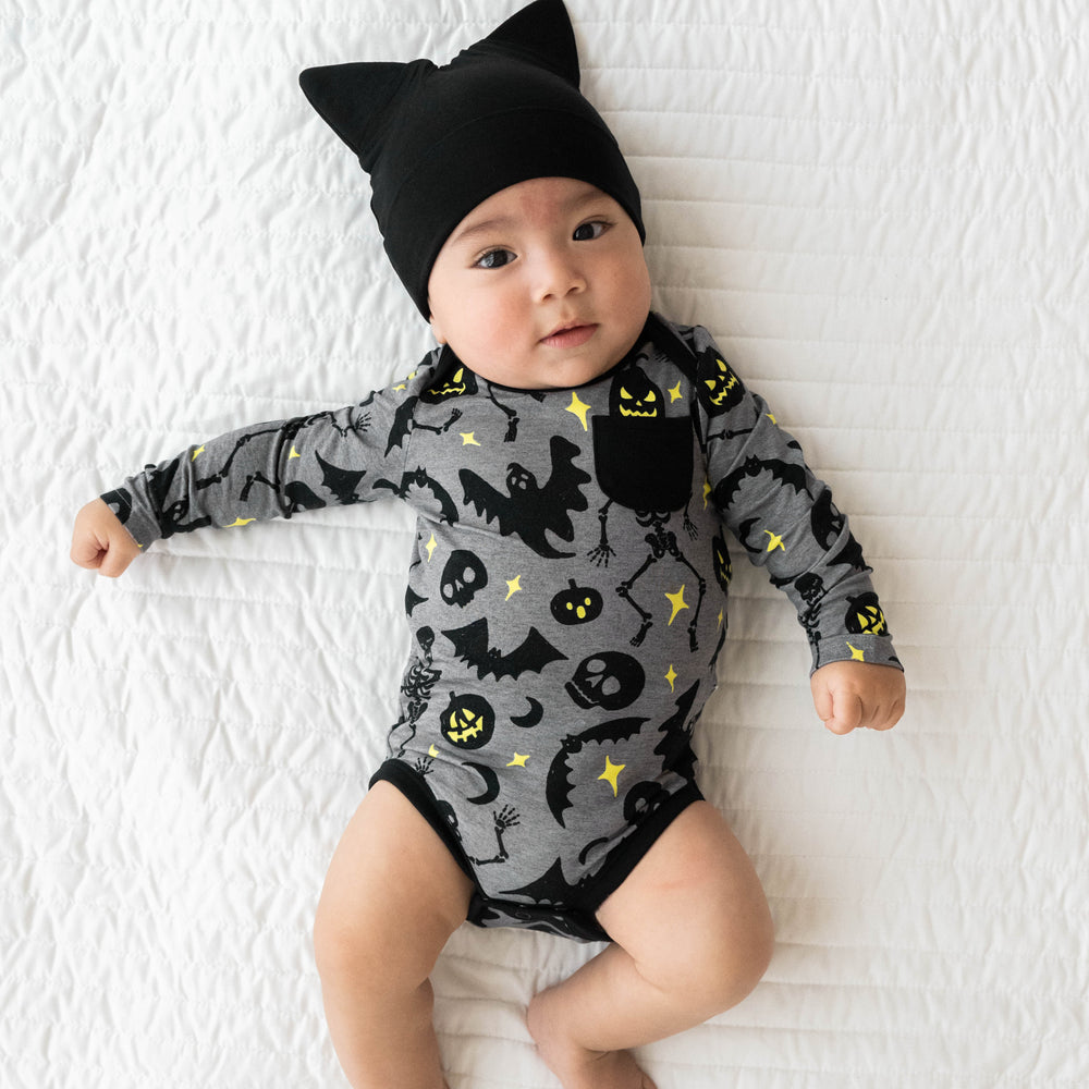 Top view image of baby laying down while wearing the Gray Glowing Ghouls Pocket Bodysuit