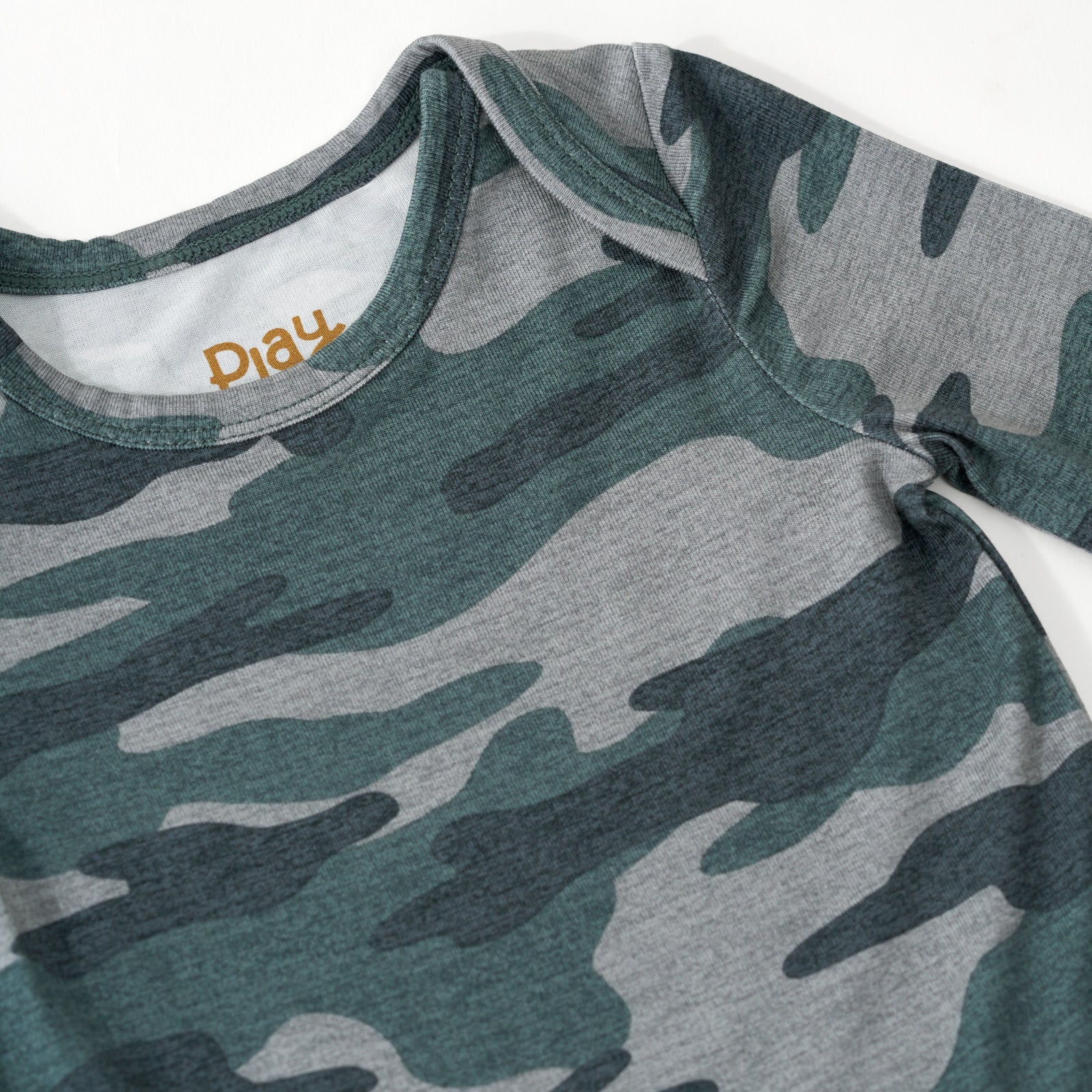 Close up flat lay image of the shoulder detail on the Vintage Camo Bodysuit