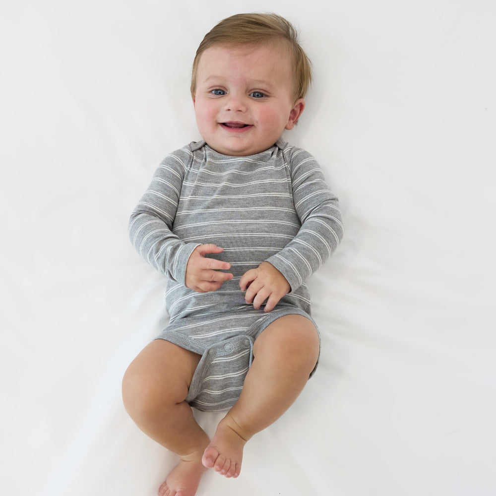 Top view image of baby laying down while wearing the Light Heather Gray Stripes Bodysuit