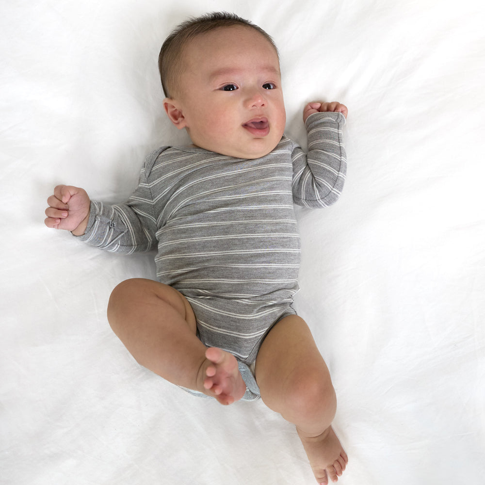 Additional top view image of bay laying down while wearing the Light Heather Gray Stripes Bodysuit