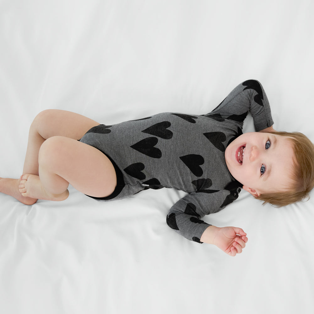 Infant lying on a blanket wearing a Heather Hearts Bodysuit