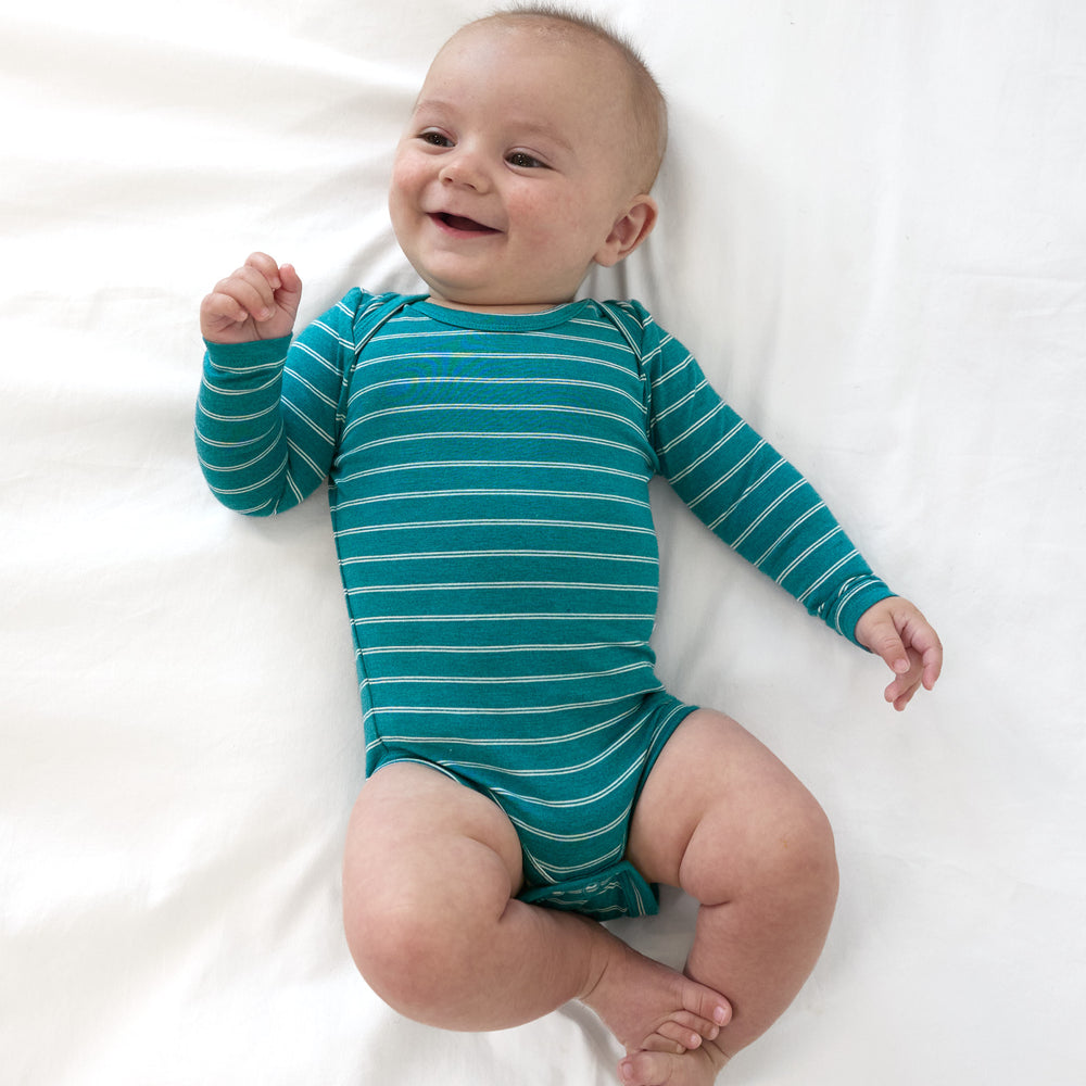 Alternative top view image of baby laying down while wearing the Glacier Stripes Bodysuit