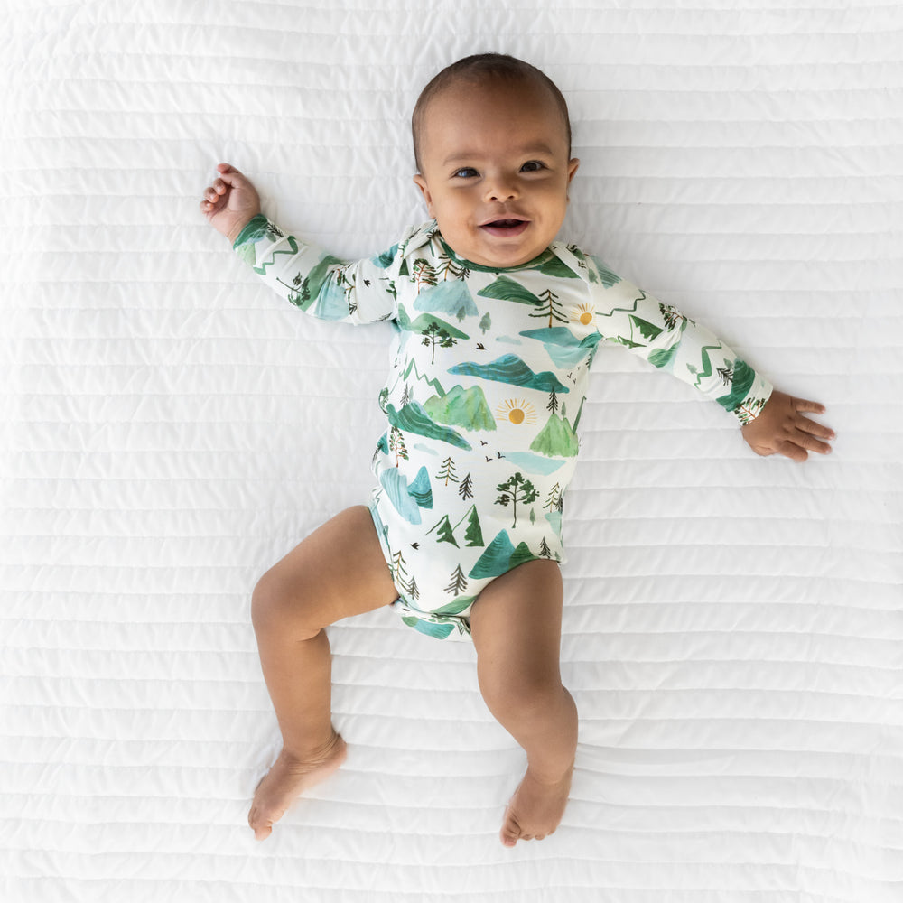 Alternate image of a child laying on a blanket wearing a Mountain Mist Bodysuit