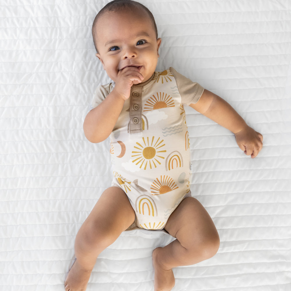 Alternate image of an infant laying on a blanket wearing a Desert Sunrise Henley Bodysuit