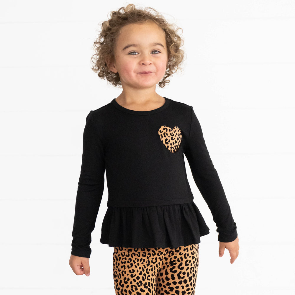 Girl wearing the Classic Leopard Pocket Peplum Tee