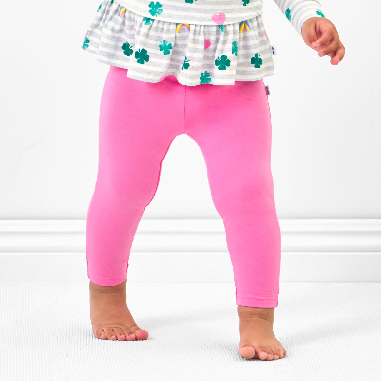 Close up image of a child wearing Sweet Pink Leggings paired with a Lucky in Love pocket peplum tee