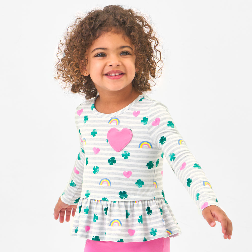 Click to see full screen - Child wearing a Lucky in Love pocket peplum tee