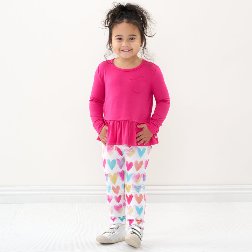 Click to see full screen - Child wearing a Pink Punch peplum tee and coordinating leggings