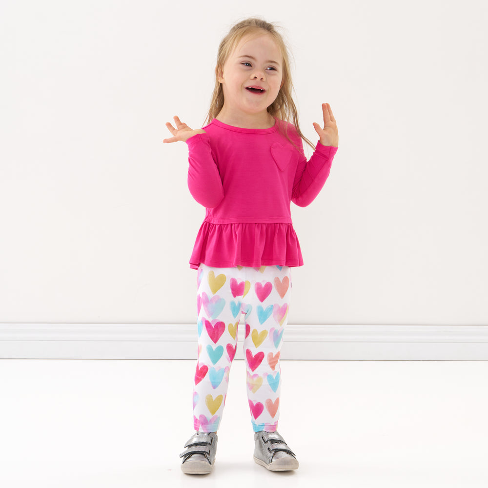 Click to see full screen - Child laughing wearing a Pink Punch peplum tee and coordinating leggings