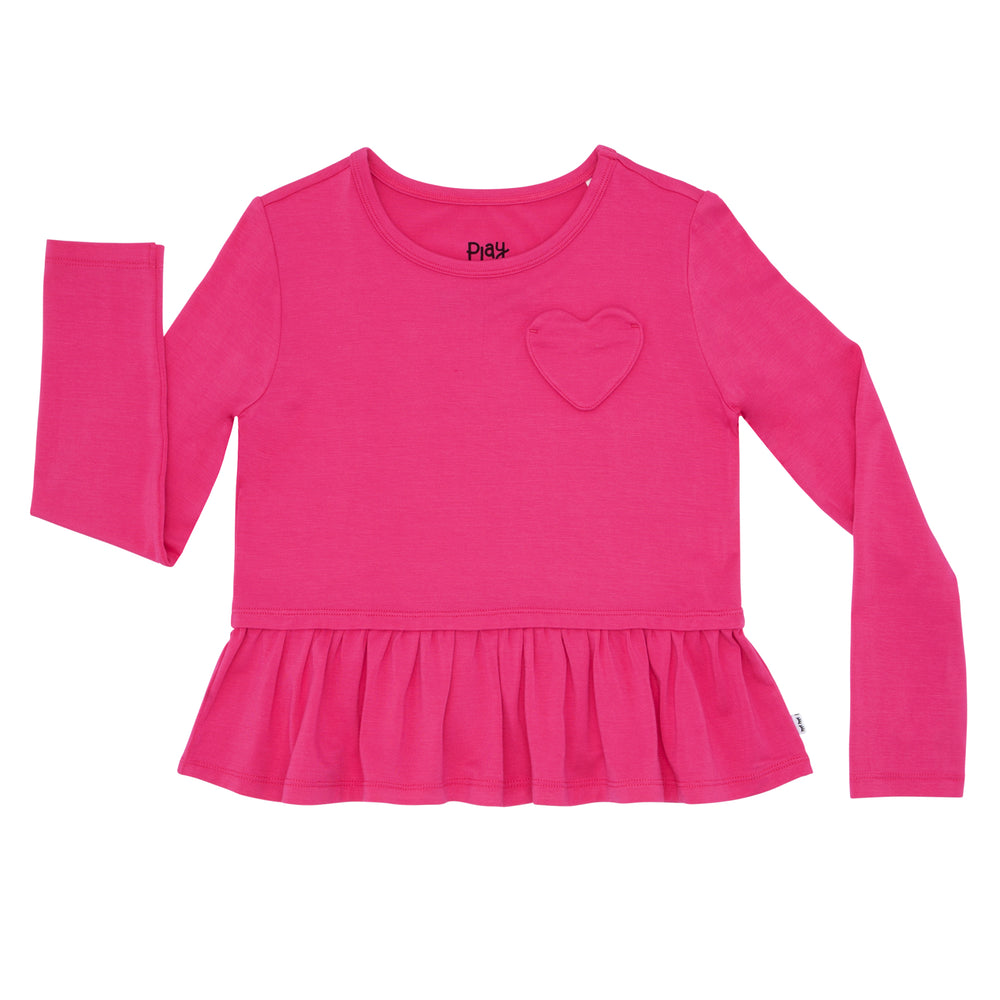 Click to see full screen - Flat lay image of a Pink Punch peplum tee