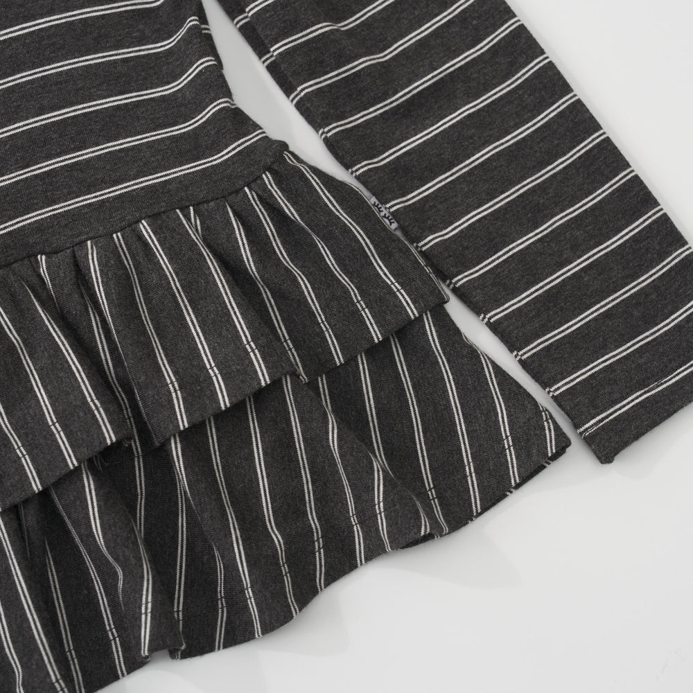 Close-up view of the tiered ruffled peplum bottom and white striped pattern on a Heather Black Stripes long sleeve peplum top