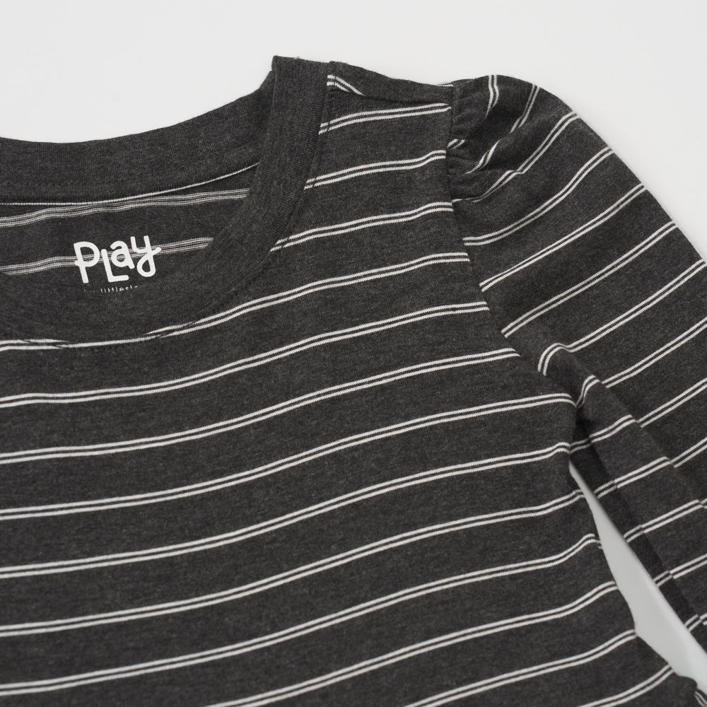 Close-up view of the shoulder puff sleeve on a Heather Black Stripes long sleeve tiered peplum top