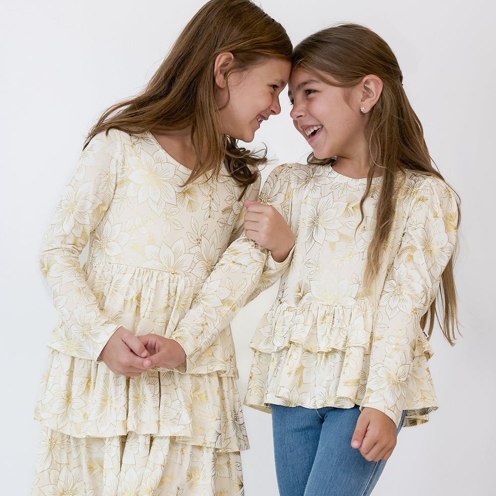 Two girls wearing matching Golden Blooms Play styles