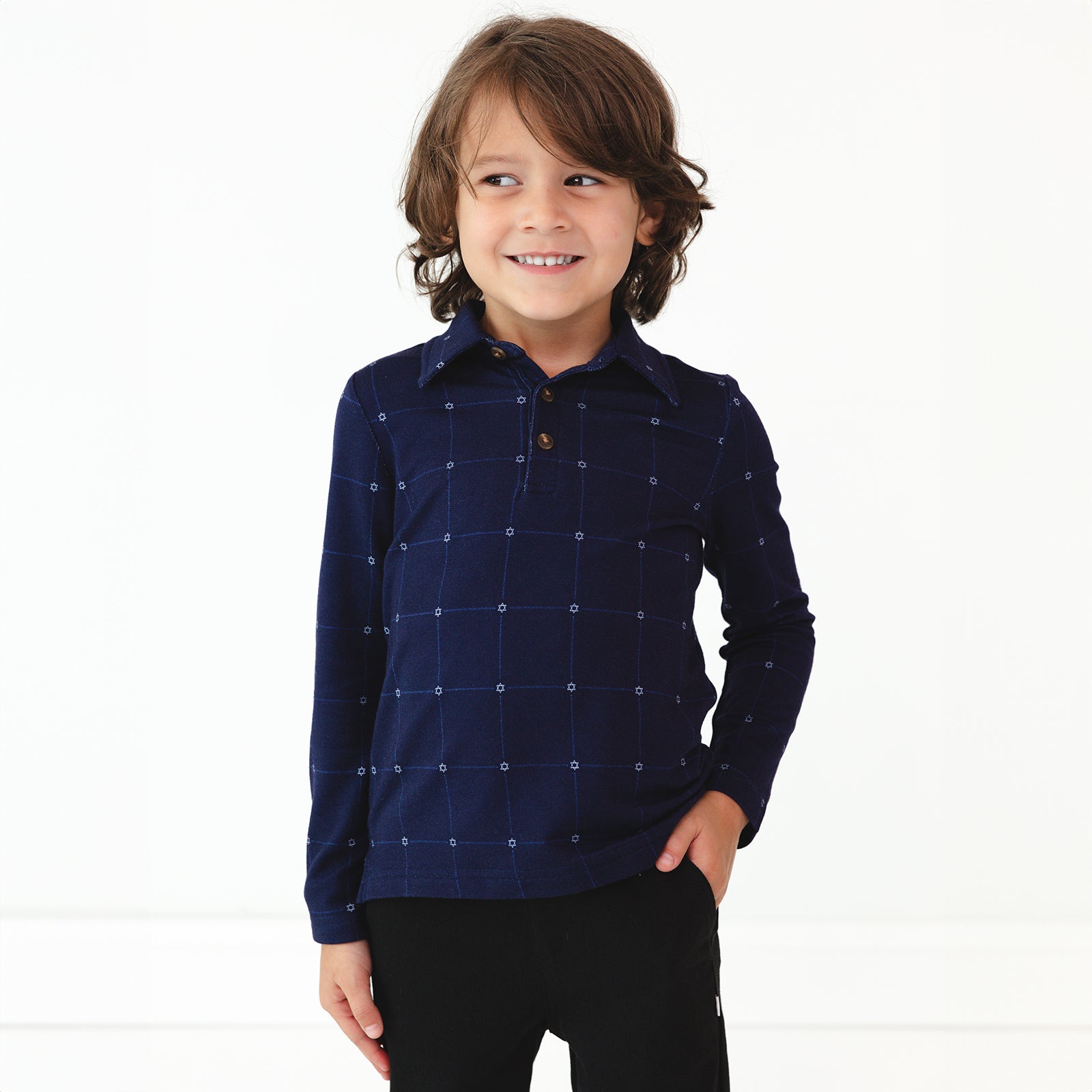 Child wearing a Hanukkah Stars Plaid Polo Shirt and Black Denim Jogger