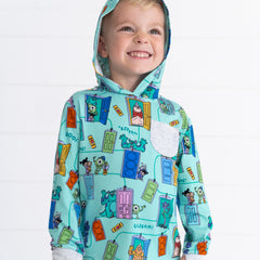 Close up image of smiling boy wearing the Disney Monsters, Inc. Scream Team Hooded Tee with the hood up