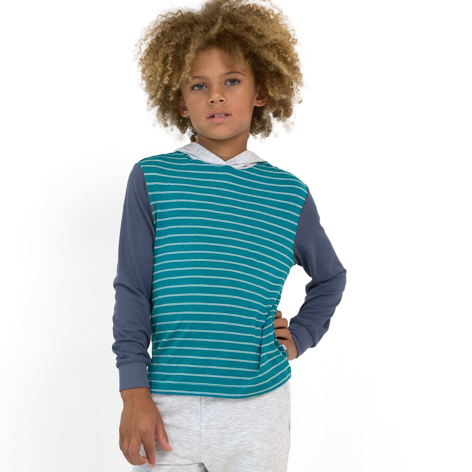 Child posing while wearing the Glacier Stripes Relaxed Hooded Tee