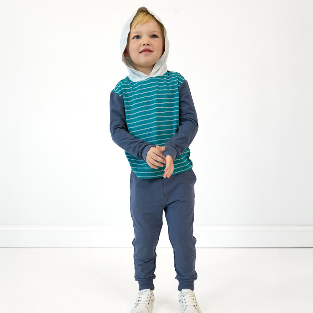 Boy posing with hood up wearing the Glacier Stripes Relaxed Hooded Tee and  Vintage Navy Jogger