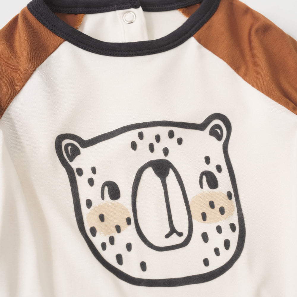 Close-up view of the black bear illustration on an Arctic Raglan baby bodysuit