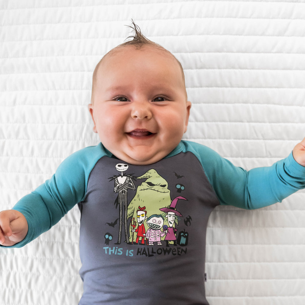 Top view and close up image of baby laying down in the Disney Jack & Crew Graphic Raglan Bodysuit