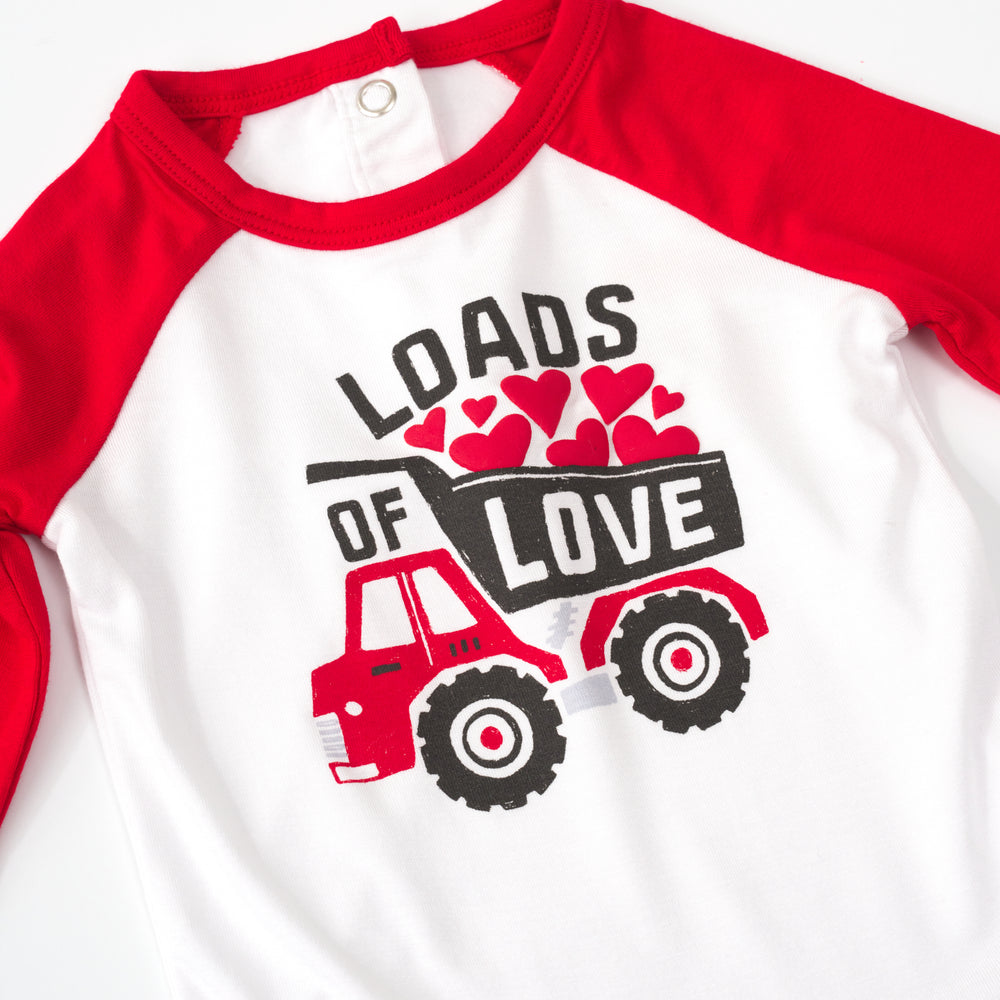 close up flat lay of a loads of love raglan bodysuit