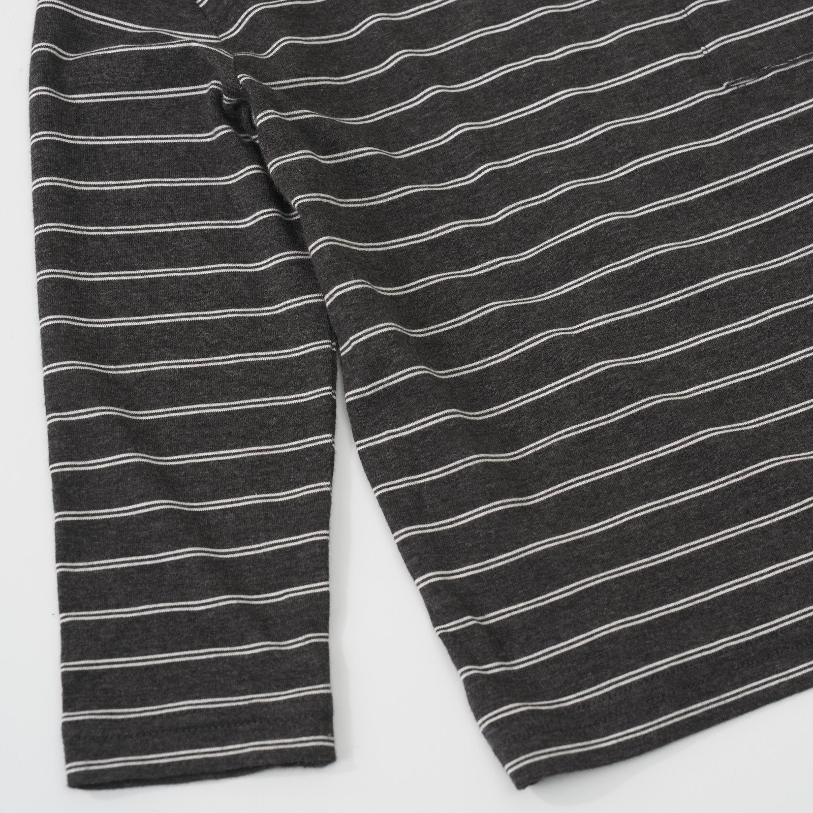 Close-up view of the white stripe pattern on a Heather Black Stripes long sleeve relaxed pocket tee