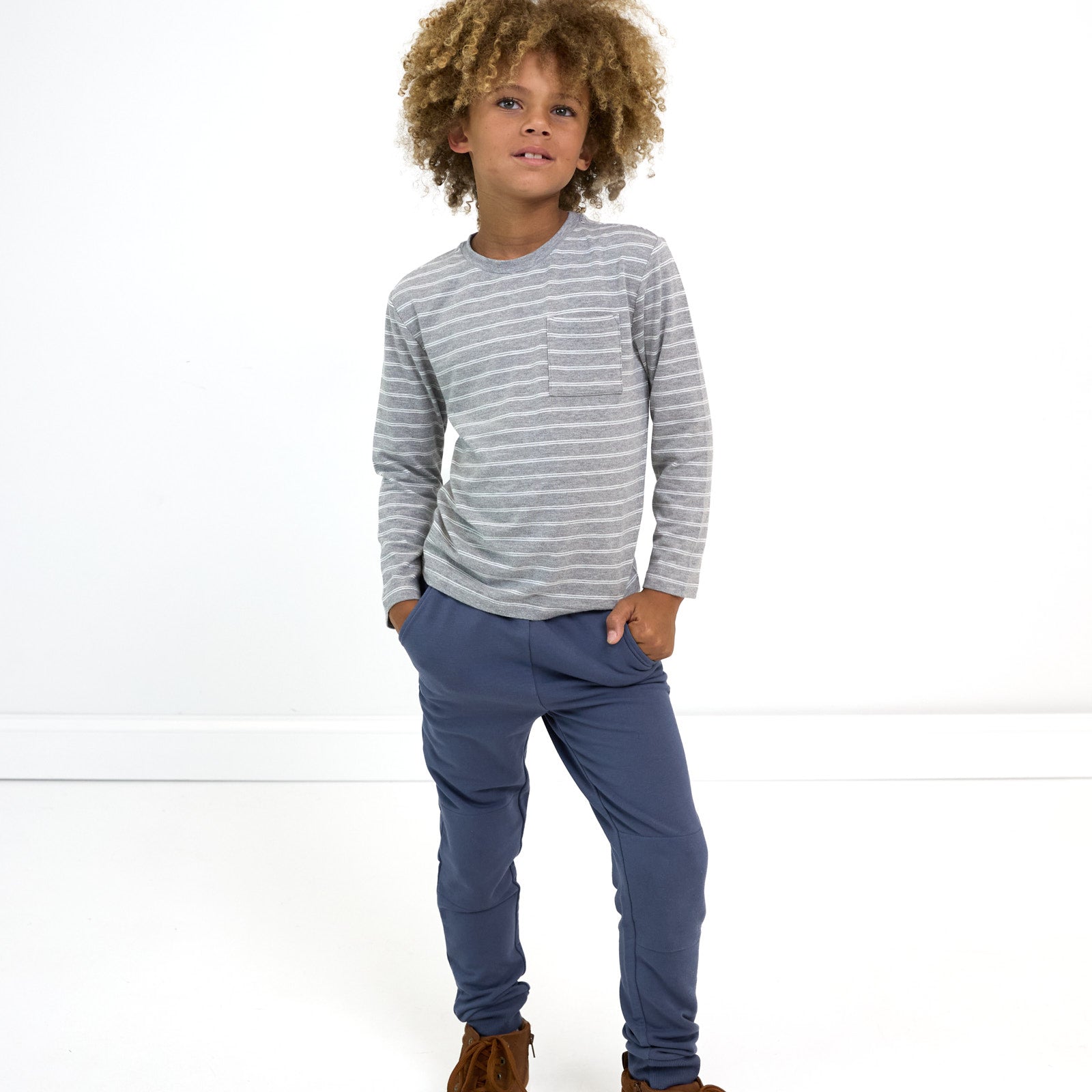 Boy posing while wearing the Light Heather Gray Stripes Relaxed Pocket Tee