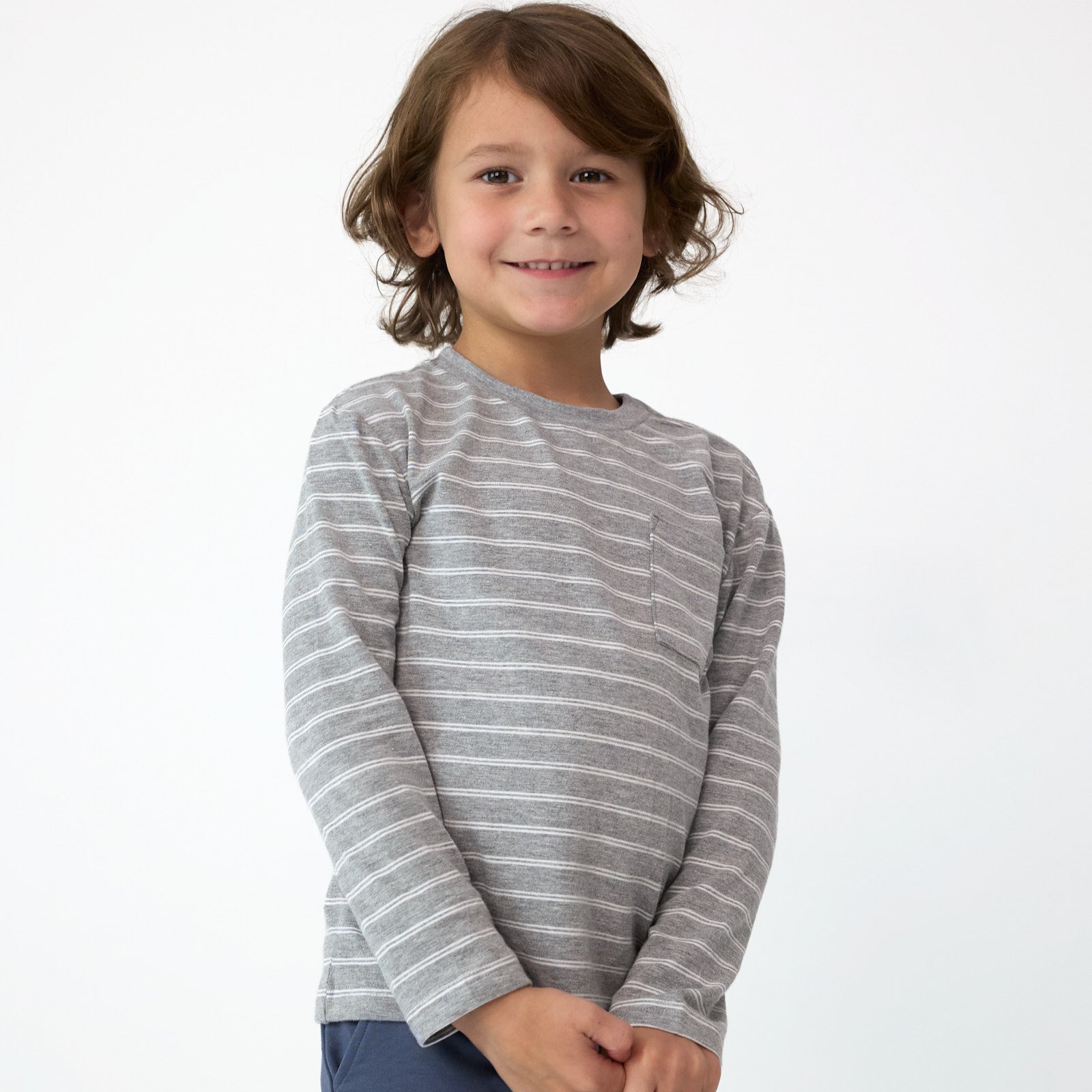 Close up image of smiling boy wearing the Light Heather Gray Stripes Relaxed Pocket Tee