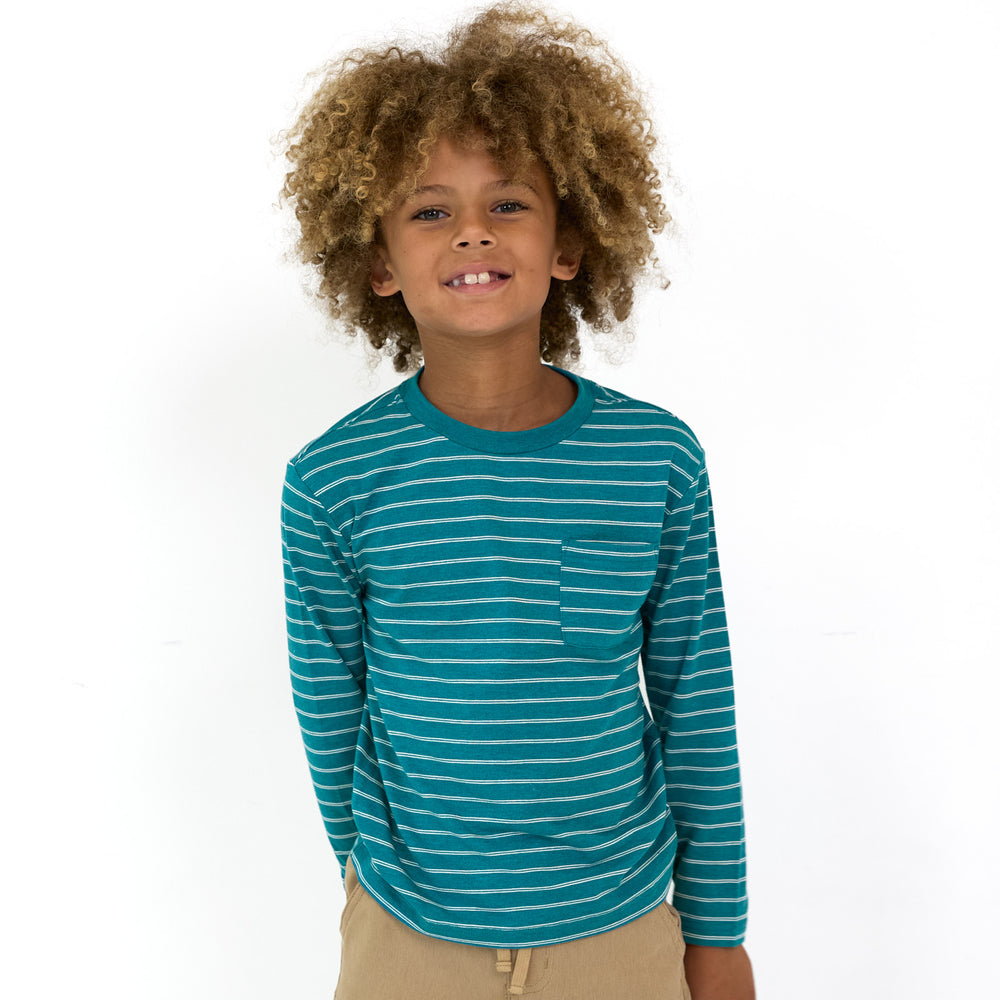 Smiling boy wearing the Glacier Stripes Relaxed Pocket Tee