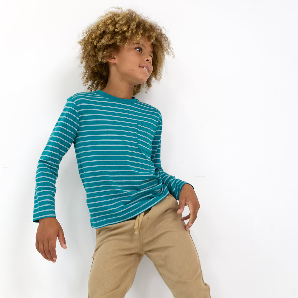 Boy posing while wearing the Glacier Stripes Relaxed Pocket Tee and Toasted Hazelnut Denim Jogger