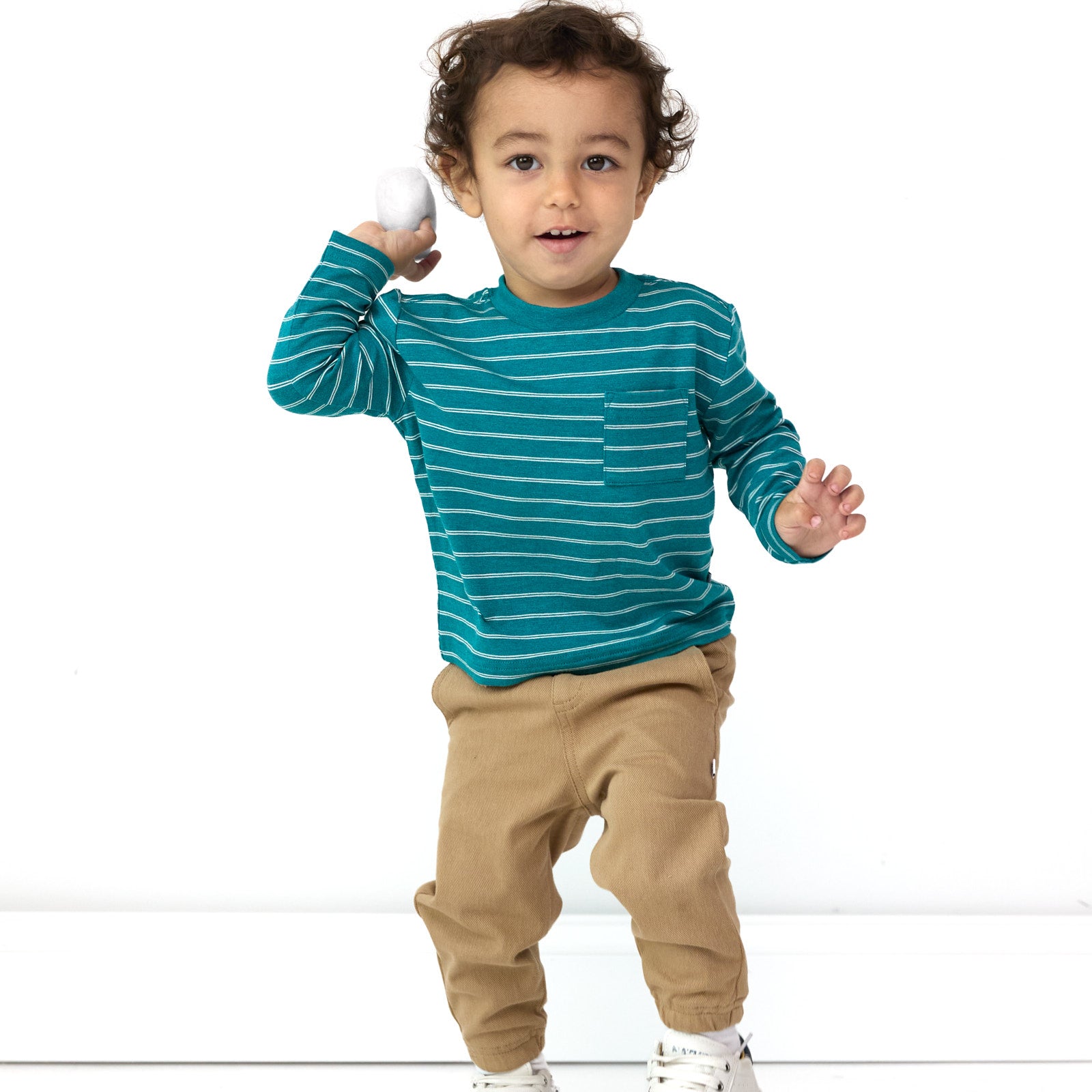 Additional image of boy posing while wearing the the Glacier Stripes Relaxed Pocket Tee and Toasted Hazelnut Denim Jogger