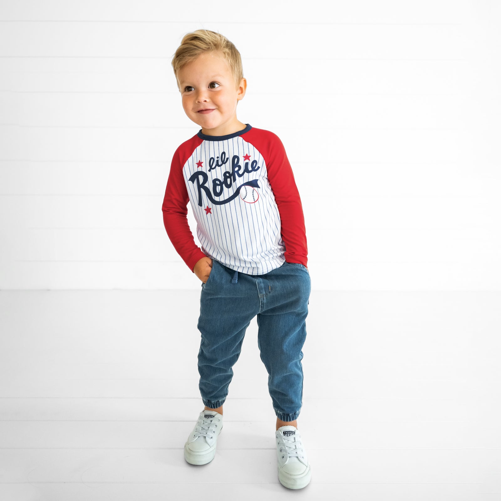 Image of a child wearing a Blue Lil Rookie Raglan Tee and Midwash Blue Denim Jogger