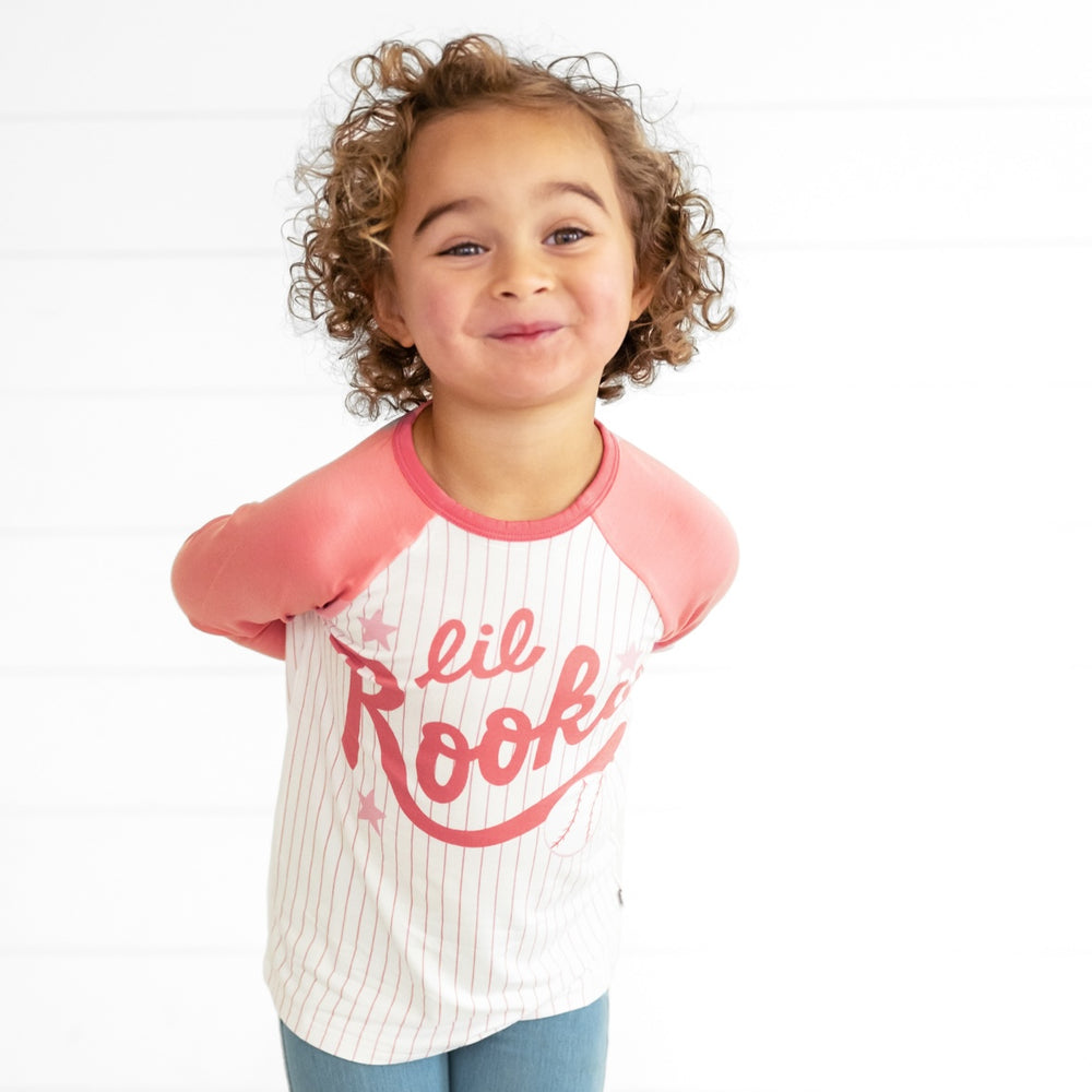 Alternate close up image of a child wearing a Pink Lil Rookie Raglan Tee and Light Blue Denim Jegging