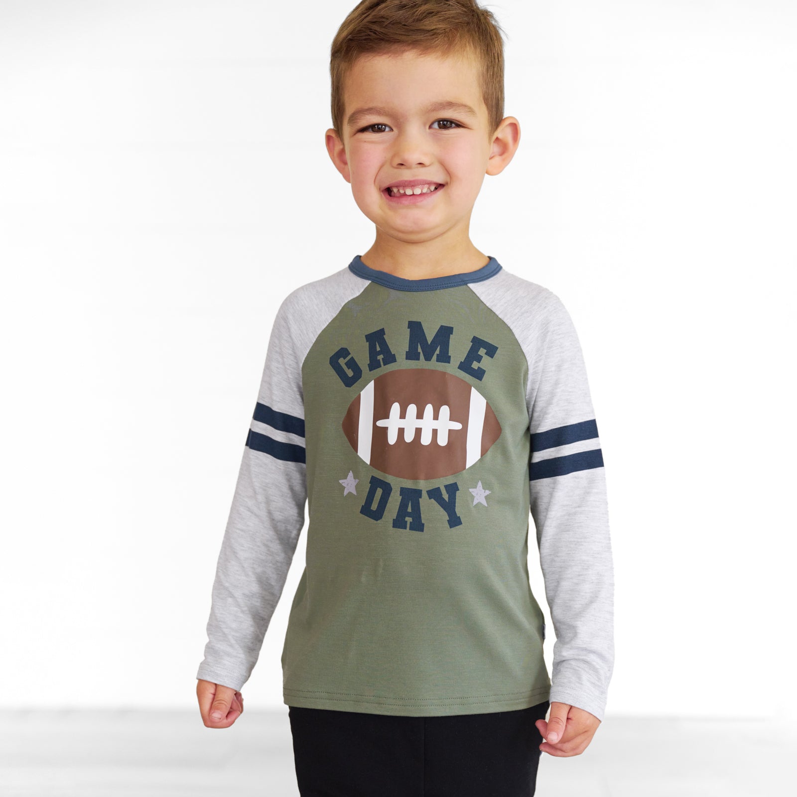 Close up image of a child wearing a Game Day Raglan Tee and Black Jogger